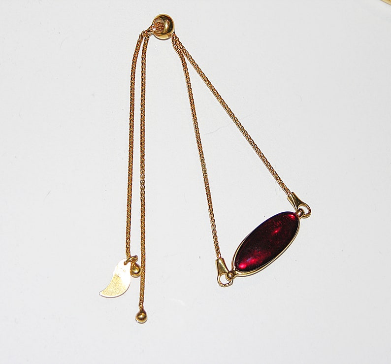 Red baltic amber and gold plated sterling silver charm bracelet