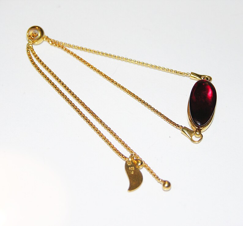 Red baltic amber and gold plated sterling silver charm bracelet