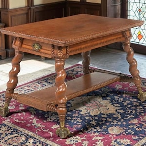 May include: A rectangular wooden side table featuring a single drawer with a brass pull, four barley twist legs, and a lower shelf. The table edges are carved with a rope pattern, and each leg terminates in a metal claw and ball foot design.