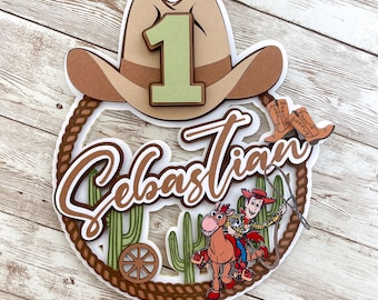 May include: A brown cowboy hat with a green number one on top. The hat is surrounded by a brown rope and a white background. The name Sebastian is written in brown cursive letters. A cartoon image of Woody from Toy Story riding a horse is in the bottom right corner.