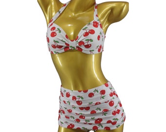 May include: White cherry print bikini top and high-waisted skirt with red cherries.