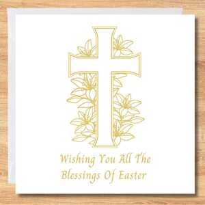 May include: White Easter greeting card with a gold cross and floral design. The card includes the message "Wishing You All The Blessings Of Easter" in gold script, suitable for Easter greetings.