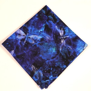 May include: A blue fabric square with a pattern of silver dragonflies on a dark blue background with white and blue watercolor-like accents.