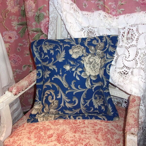 Un coussin réalisé en tissu ancien , motifs de roses, fond bleu