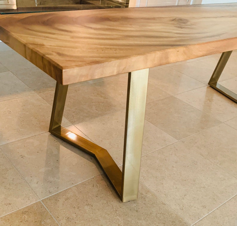 Trapezoidal table legs in an eye-catching brushed gold finish.  Shiny legs in gold powder coat look amazing with epoxy river table or live edge wood top.  The oak top combined with the YAKO trapezoidal legs will be your favorite dining room table.