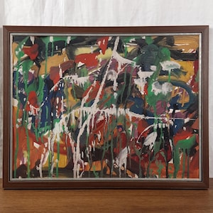 May include: Abstract painting in a wooden frame with a colorful, chaotic design featuring splashes of red, green, white, and black paint.