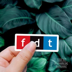 sticker featuring parody of the NPR logo with the letters fdt over a background with green leaves