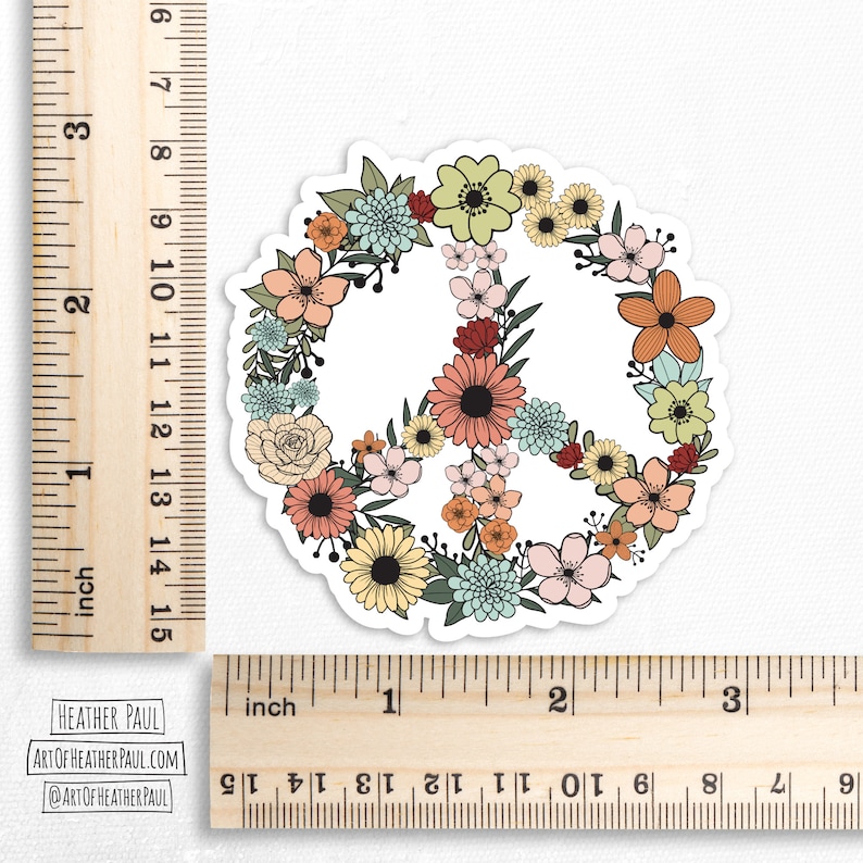 May include: A peace sign sticker with a floral design. The peace sign is outlined in black and filled with a variety of flowers in shades of pink, yellow, orange, blue, and green.
