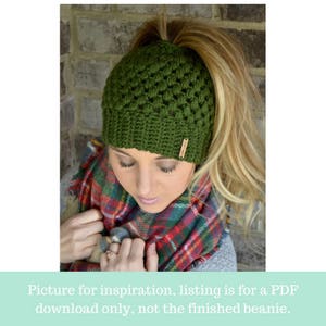 crochet messy bun hat modeled by beautiful blond woman in the color dark green