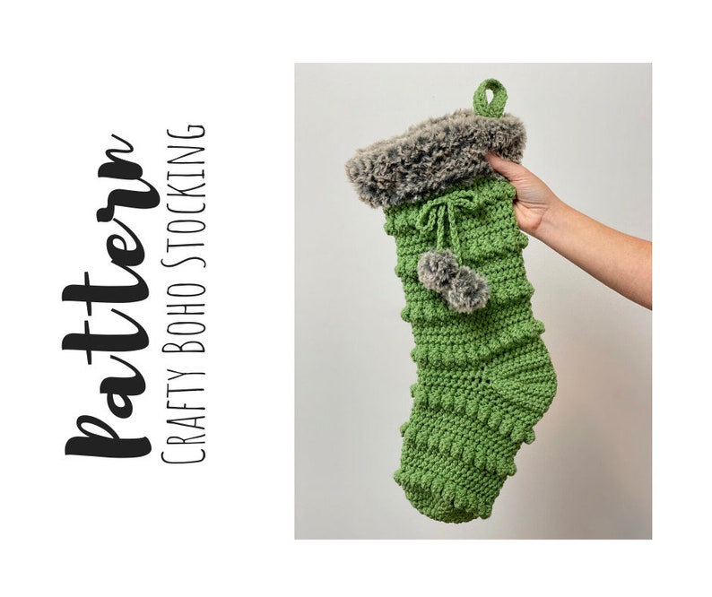 May include: Green crocheted Christmas stocking with a faux fur cuff and a pom-pom. The stocking is hanging from a loop at the top. "Crafty Boho Stocking" is written in black text on a white background.
