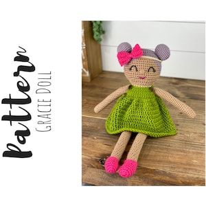 Crochet doll wearing a green dress, pink shoes and purple hair. Listing is for a crochet doll pattern and not the finished piece.