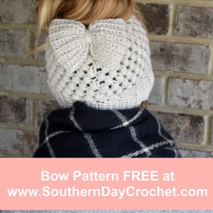 crochet messy bun beanie modeled by beautiful blond woman in the color linen with a bow attached under the bun