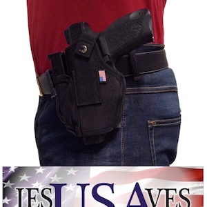 May include: A black gun holster with a small American flag patch attached to it. The holster is worn on a person's waist with a black belt. The holster is made of a durable nylon material and has a secure snap closure.