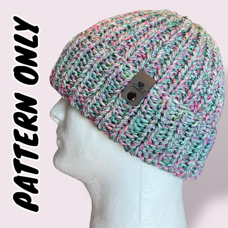 May include: A green, pink, and white crocheted beanie with a black leather label that says "Love, Handmade".