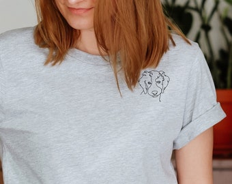 May include: A grey t-shirt with a simple line drawing of a dog's face on the left side of the chest.