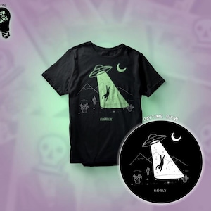 May include: Black t-shirt with a glow-in-the-dark design of a UFO abducting a person. The design includes the text "Finally" and "Daytime View".
