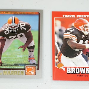 May include: Two football trading cards. One card features Bernard Warren in a Browns uniform, labeled "2001 ROOKIE CARD." The other card shows Travis Prentice in a Browns uniform. Both cards have the Browns logo and team colors.