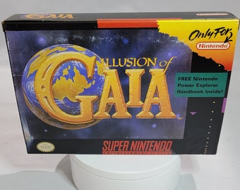 May include: A Super Nintendo game cartridge box for the game Illusion of Gaia. The box is black with a gold and blue image of a globe. The text "Only For Nintendo" is written in white on a red background in the upper right corner. The text "FREE Nintendo Power Explorer Handbook Inside!" is written in white on a green background in the lower right corner.