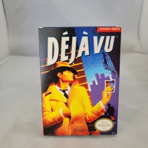 May include: A vintage video game cartridge box for the game "Déjà Vu" by Kemco and Seika. The box features a detective in a yellow trench coat standing in front of a brick wall. The game is rated for ages 17 and up.