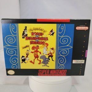 May include: A Super Nintendo Entertainment System game cartridge for The Adventures of Rocky and Bullwinkle and Friends. The game cartridge is yellow with a blue and gold border. The front of the cartridge features a cartoon image of Rocky the Flying Squirrel, Bullwinkle the Moose, and their friends.