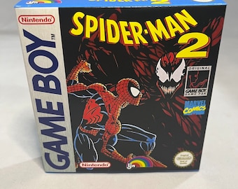 May include: A boxed Nintendo Game Boy game, "Spider-Man 2," featuring a comic book-style illustration of Spider-Man in action. The box has a blue top and sides, with the Nintendo and Marvel Comics logos visible. The game is a Game Boy Game Pak.
