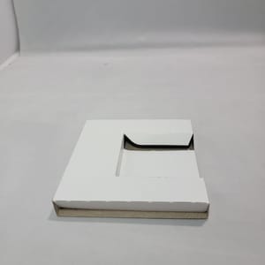 May include: White cardboard box with a cut-out shape in the center. The box is folded and has a brown cardboard bottom.