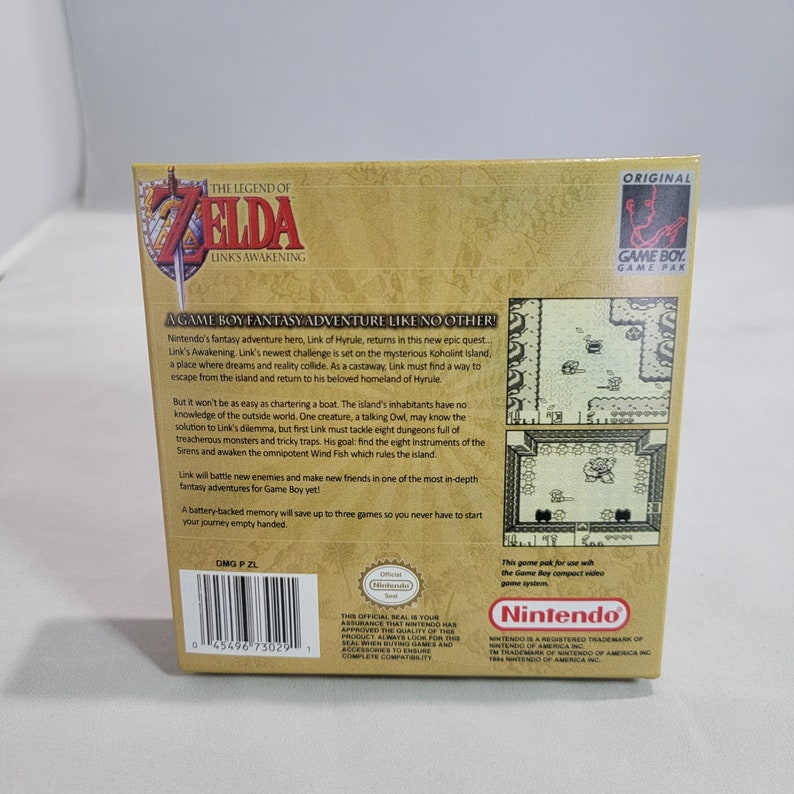 May include: The Legend of Zelda: Link's Awakening Game Boy game cartridge box art. The box is brown with gold accents and features a picture of Link on the front. The back of the box has a description of the game and a picture of the game screen. The box is in good condition.