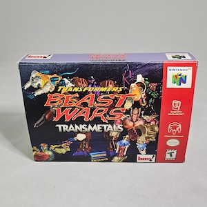 May include: A Nintendo 64 game cartridge for Transformers: Beast Wars Transmetals. The box art features a colorful illustration of the Transformers characters, including Optimus Primal, Cheetor, and Megatron. The game is a Blockbuster exclusive.