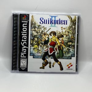 May include: A PlayStation game case for Suikoden II. The cover art shows several characters in a fantasy setting, with the game's title in blue. The case is in a clear plastic case with the PlayStation logo on the side.