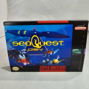 May include: A Super Nintendo Entertainment System game cartridge box for Seaquest DSV. The box features a blue and yellow colour scheme with a submarine and dolphins. The game is licensed by Nintendo and published by Malibu Games.