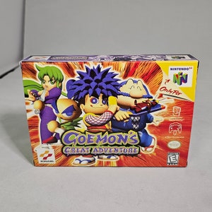 May include: A Nintendo 64 game cartridge case for "Goemon's Great Adventure". The case is orange, purple, and yellow with a cartoon image of four characters. The game is rated "E" for Everyone by the ESRB.