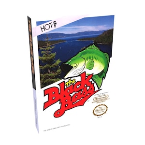 May include: A video game cartridge for the Nintendo Entertainment System, featuring a red and white logo for "The Black Bass" with a green and white bass fish jumping out of the water. The game is licensed by Nintendo.
