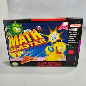 May include: A Super Nintendo Entertainment System game cartridge box for Math Blaster Episode 1. The box features a colorful cartoon design with a green alien character, a yellow alien character, and a pizza. The text on the box reads "Math Blaster Episode 1" and "Super Nintendo Entertainment System".