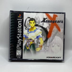 May include: A PlayStation game case for Xenogears. The cover art features a character with long black hair and a white and blue outfit. The title "Xenogears" is in orange, with the SquareSoft logo at the bottom.