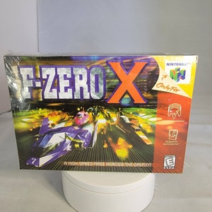 May include: A Nintendo 64 game cartridge case for F-Zero X, a high-speed race across the galaxy. The case is purple, orange, and silver with a futuristic design. The game is rated E for Everyone.