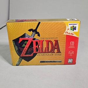 May include: A gold Nintendo 64 game cartridge case for The Legend of Zelda: Ocarina of Time, Collectors Edition. The case features a red and black image of Link's sword and shield.