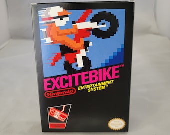 May include: A black Nintendo Entertainment System game cartridge box with a pink and white title, "EXCITEBIKE". The front of the box features a pixelated image of a person riding a motorcycle on a blue and white background.