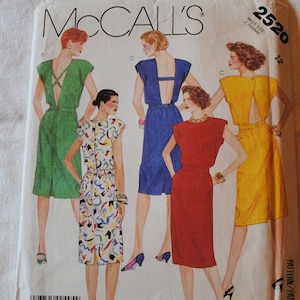 May include: A sewing pattern for four dresses with a back cutout. The pattern is McCall's 2520, size 12, for misses. The dresses are in green, yellow, red, and blue.