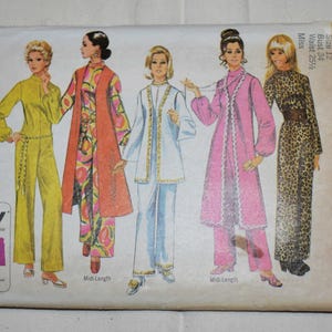 May include: Vintage Simplicity sewing pattern envelope featuring illustrations of five women in various outfits. The envelope includes the text "Jiffy" and "9071 Simplicity". The outfits include jumpsuits, pantsuits, and a leopard print dress.