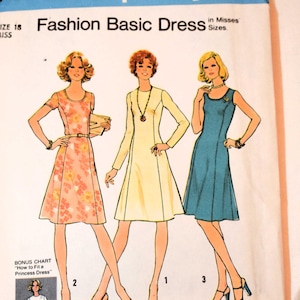 May include: A Simplicity 7026 sewing pattern envelope for a Fashion Basic Dress in size 18. The cover features illustrations of three variations of the dress in floral, yellow, and blue, along with a bonus chart for fitting a princess dress.