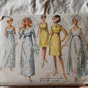 May include: A vintage Simplicity sewing pattern for a dress with a train. The pattern is for sizes 12-14-16-18 and is priced at 75 cents. The pattern shows four different views of the dress, including a jacket and train.