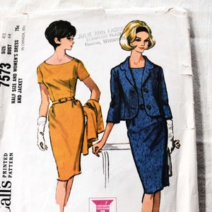May include: Vintage McCall's sewing pattern envelope for a dress and jacket. The pattern number is 7573. The envelope features a line drawing of two women wearing the dress and jacket. The dress is yellow and the jacket is blue.