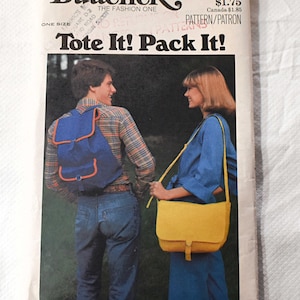 May include: Vintage Butterick sewing pattern titled "Tote It! Pack It!" featuring a blue backpack with orange trim and a yellow shoulder bag. The pattern cover shows two people wearing the bags. The pattern number is 5290.
