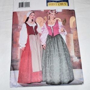 Puede incluir: Un sobre de patrón de costura Butterick con un diseño de vestuario medieval. El sobre muestra a dos mujeres con vestidos históricos con faldas largas, corpiños y blusas de manga larga. El número de patrón es 6196, con la palabra "History" visible.