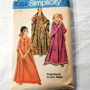 May include: Vintage Simplicity sewing pattern 8354 featuring illustrations of three different caftan designs. The pattern envelope is cream-colored with blue text and illustrations. The text "Proportioned to your Height" is printed on the bottom right.