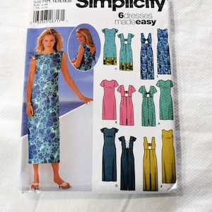 May include: Simplicity sewing pattern with six dress designs. The pattern shows a woman in a blue floral dress. The pattern includes the size range, the brand name, and the phrase "6 dresses made easy."