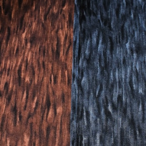 May include: Close-up of two fabric swatches with a woodgrain pattern. The swatch on the left is brown with a darker brown pattern. The swatch on the right is blue with a darker blue pattern.