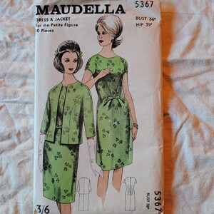 May include: Maudella sewing pattern 5367 for a dress and jacket for the petite figure. The pattern includes 10 pieces and is for a bust size of 36 inches and a hip size of 39 inches. The pattern shows a green dress and jacket with a floral print.