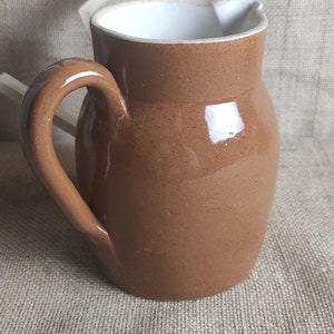 Old pitcher jug in brown glazed stoneware French bistro pitcher