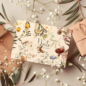 May include: A save the date card with a floral design featuring butterflies and the text "Save the Date!" with the date "July 08, 2022".
